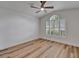 Bright bedroom with hardwood floors, neutral paint, ceiling fan and plantation shutters at 10412 Tara Dr, Riverview, FL 33578