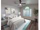 Inviting bedroom with a plush bed, neutral decor, and large windows for natural light at 10412 Tara Dr, Riverview, FL 33578