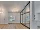 Dining room featuring wood floors, modern chandelier, and built in window to view the connecting room at 10412 Tara Dr, Riverview, FL 33578