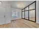 Dining room featuring wood floors, modern chandelier, and built in window to view the connecting room at 10412 Tara Dr, Riverview, FL 33578