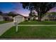 Charming single-story home featuring a lush green lawn, mature trees, and a two-car garage at 10412 Tara Dr, Riverview, FL 33578