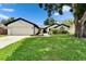 Charming single-story home with a well-manicured lawn, attached two-car garage, and inviting curb appeal at 10412 Tara Dr, Riverview, FL 33578