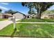 Charming single-story home with a well-manicured lawn, attached two-car garage, and inviting curb appeal at 10412 Tara Dr, Riverview, FL 33578