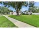 Charming home with mature trees, a well-manicured lawn, and a welcoming sidewalk at 10412 Tara Dr, Riverview, FL 33578