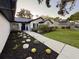 Landscaped front yard with walkway leading to a well-maintained home featuring updated shutters and fresh plants at 10412 Tara Dr, Riverview, FL 33578