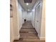 Clean hallway featuring fresh paint, modern flooring, and storage closets at 10412 Tara Dr, Riverview, FL 33578