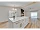 Open concept kitchen with island, stainless appliances, and hardwood floors at 10412 Tara Dr, Riverview, FL 33578