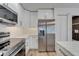 Modern kitchen with stainless appliances, white cabinets, and marble countertops at 10412 Tara Dr, Riverview, FL 33578