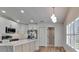 Modern kitchen with white cabinets, stainless appliances, and quartz countertops at 10412 Tara Dr, Riverview, FL 33578