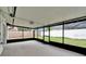 The screened-in lanai offers a relaxing space with views of the backyard and surrounding landscape at 10412 Tara Dr, Riverview, FL 33578