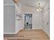 Inviting entryway with wood-look flooring, neutral paint, and modern lighting fixture at 10412 Tara Dr, Riverview, FL 33578