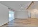 Open living room with wood-look floors, beam, and lots of natural light at 10412 Tara Dr, Riverview, FL 33578