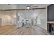 Open concept living room and kitchen with stainless appliances and wood-look flooring at 10412 Tara Dr, Riverview, FL 33578