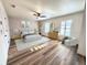 Spacious main bedroom featuring hardwood floors, ceiling fan and sitting area at 10412 Tara Dr, Riverview, FL 33578