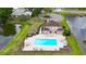 Aerial view of the community pool, showcasing its ample lounge space and tranquil lakeside setting at 10412 Tara Dr, Riverview, FL 33578
