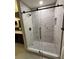 Modern shower featuring marble tile, glass door, and black hardware at 10412 Tara Dr, Riverview, FL 33578