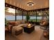 Inviting sunroom featuring a cozy sectional sofa, fire pit, egg chair and stylish decor at 10412 Tara Dr, Riverview, FL 33578