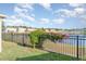 Fenced backyard with a view of the serene lake, perfect for relaxation and outdoor activities at 10424 Laguna Plains Dr, Riverview, FL 33578