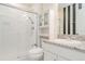 Bathroom with white cabinets, granite countertop, and walk-in shower at 10424 Laguna Plains Dr, Riverview, FL 33578