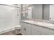 Bright bathroom with dual sinks, granite countertop, shower with glass doors at 10424 Laguna Plains Dr, Riverview, FL 33578