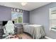 A blue toned bedroom with a ceiling fan and moons over a window at 10424 Laguna Plains Dr, Riverview, FL 33578