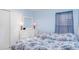 Light blue bedroom with two twin beds, white dresser, and lamps at 10424 Laguna Plains Dr, Riverview, FL 33578