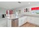 Well-equipped kitchen with granite countertops, stainless steel appliances, white cabinetry, and an open view to the dining area at 10424 Laguna Plains Dr, Riverview, FL 33578