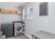 Functional laundry room with modern washer and dryer, offering convenience and efficiency at 10424 Laguna Plains Dr, Riverview, FL 33578