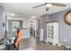 Open-concept living area with wood-look floors, leading to the laundry room and other spaces at 10424 Laguna Plains Dr, Riverview, FL 33578