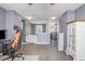 Spacious living room area with wood-look floors, connecting to the laundry area at 10424 Laguna Plains Dr, Riverview, FL 33578