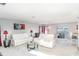 Spacious living room with sleek white furniture, modern decor, and plenty of natural light at 10424 Laguna Plains Dr, Riverview, FL 33578
