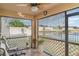 Relaxing screened-in porch with outdoor furniture and a serene view of the lake at 10424 Laguna Plains Dr, Riverview, FL 33578