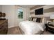 Comfortable bedroom featuring neutral tones, stylish decor, and a large window for natural light at 12172 Cattleside Dr, Riverview, FL 33579