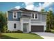 Charming two-story home with a gray color scheme, landscaped yard, and attached two-car garage at 12172 Cattleside Dr, Riverview, FL 33579
