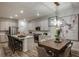 Open-concept kitchen and dining area featuring a modern light fixture and stainless steel appliances at 12172 Cattleside Dr, Riverview, FL 33579