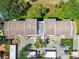 Aerial view showcases the condo building's roof, parking, and nearby playground at 13618 Greenfield Dr # 105, Tampa, FL 33618