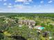 Scenic aerial view of a condo building surrounded by lush landscaping and golf course views at 13618 Greenfield Dr # 105, Tampa, FL 33618