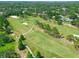 Beautiful aerial view of a verdant golf course surrounded by mature trees and residences at 13618 Greenfield Dr # 105, Tampa, FL 33618