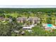 Scenic aerial view of a condo building with golf course and pool at 13618 Greenfield Dr # 105, Tampa, FL 33618