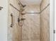 Tiled bathroom shower with convenient grab bar and built-in shelving at 13618 Greenfield Dr # 105, Tampa, FL 33618