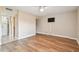 Bedroom featuring wood-look flooring, a ceiling fan, and access to a bright bathroom at 13618 Greenfield Dr # 105, Tampa, FL 33618