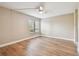 Bedroom with ceiling fan, laminate flooring, view of trees and a community green space at 13618 Greenfield Dr # 105, Tampa, FL 33618