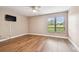 Bedroom with ceiling fan, view of golf course, and wood laminate flooring at 13618 Greenfield Dr # 105, Tampa, FL 33618