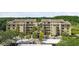 Exterior of a well-maintained building, with mature palm trees and parking at 13618 Greenfield Dr # 105, Tampa, FL 33618