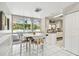 Bright dining room featuring tiled floors, a large window, and a view of the pool at 13618 Greenfield Dr # 105, Tampa, FL 33618