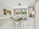 Cozy dining room with bright tile floor, and view of the pool and patio at 13618 Greenfield Dr # 105, Tampa, FL 33618