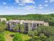Condo building featuring multiple balconies and palm trees at 13618 Greenfield Dr # 105, Tampa, FL 33618