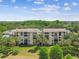 Condo building featuring multiple balconies and a view of trees at 13618 Greenfield Dr # 105, Tampa, FL 33618