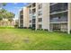 Condo building exterior with lush landscaping and serene screened in lanais at 13618 Greenfield Dr # 105, Tampa, FL 33618
