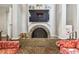 A detailed view of the brick fireplace, complemented by a large-screen TV and comfortable seating at 13618 Greenfield Dr # 105, Tampa, FL 33618
